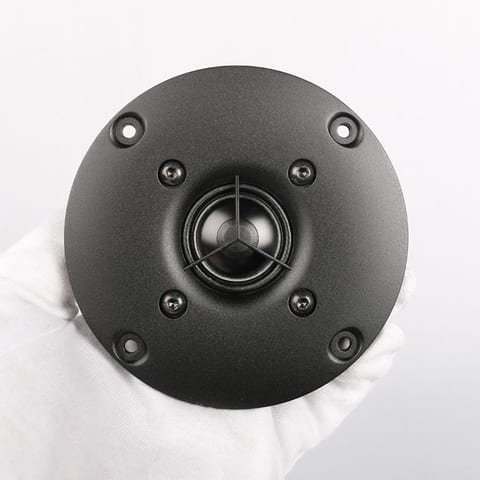 SB Acoustics SB26ADC-C000-4 tweeter seen face on: a 25.4 mm dome behind a three-arm protective grille, on a round black faceplate with six bolt holes.