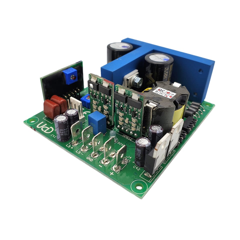 A Hypex UcD400HG amplifier module with the HxR regulator daughterboard fitted: a green circuit board with a blue anodised heatsink bracket, two power-stage sub-boards, a toroidal choke, and spade terminals marked LS+, LS- and GND along the front edge.