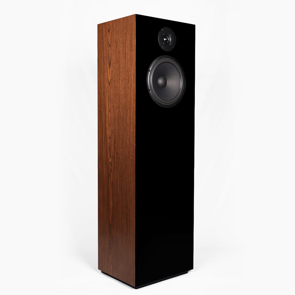 SB Acoustics Kinnara floorstander at three-quarter view, showing the front baffle with an 8-inch woofer below a dome tweeter.