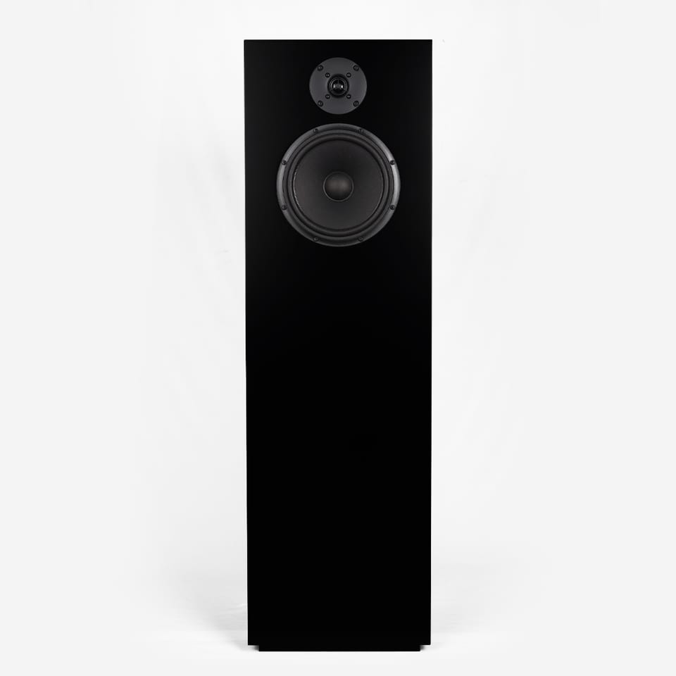 SB Acoustics Kinnara floorstander seen from the front, showing the 8-inch paper woofer below a 26 mm aluminium dome tweeter on a tall narrow baffle.