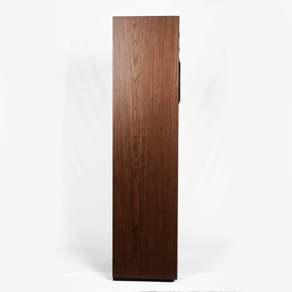 Kinnara floorstander in pure side profile, walnut veneer, tall and narrow with a flat top.