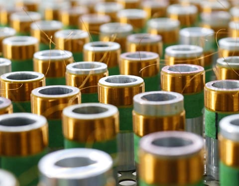 Rows of loudspeaker voice coils on the production line at the Sinar Baja Electric factory.