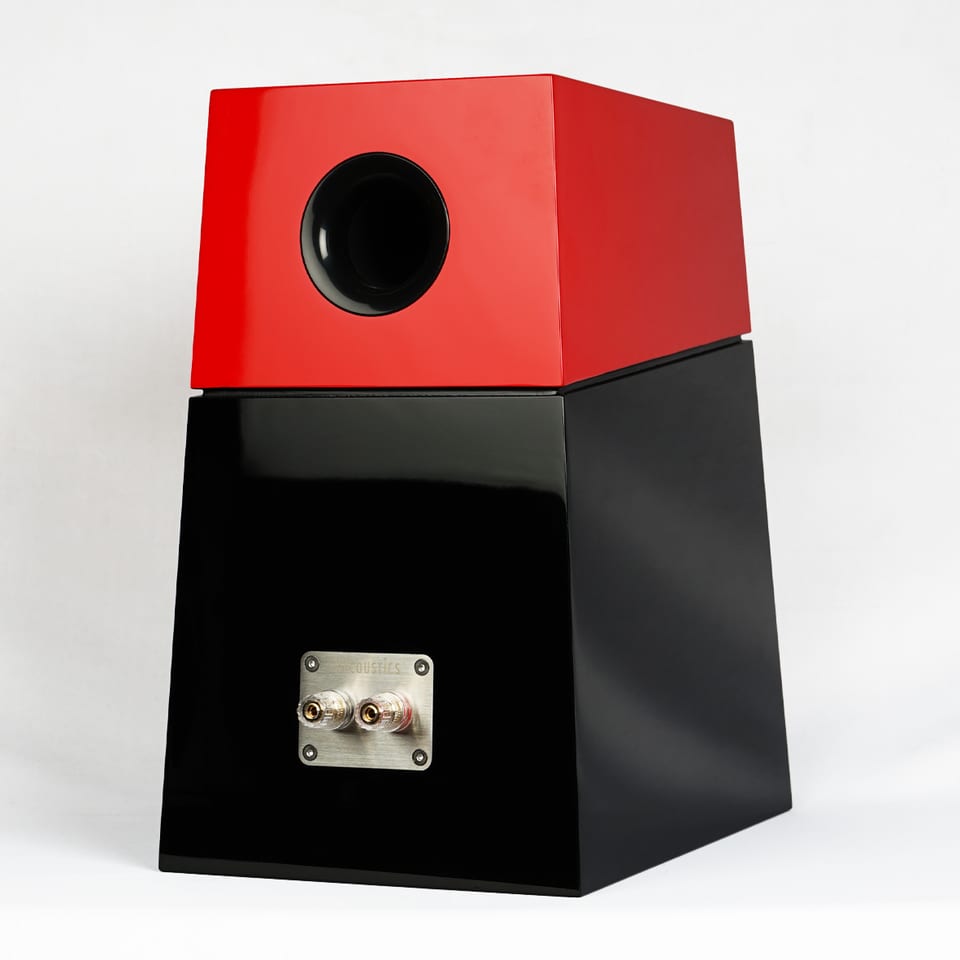 Tifa 6 from the rear three-quarter: a large circular port opening in the red upper module and a terminal plate on the black lower cabinet.