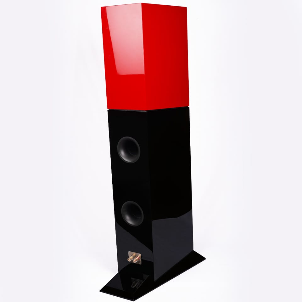 Tifa 8 from the rear three-quarter, showing two circular port openings down the back of the black lower cabinet.